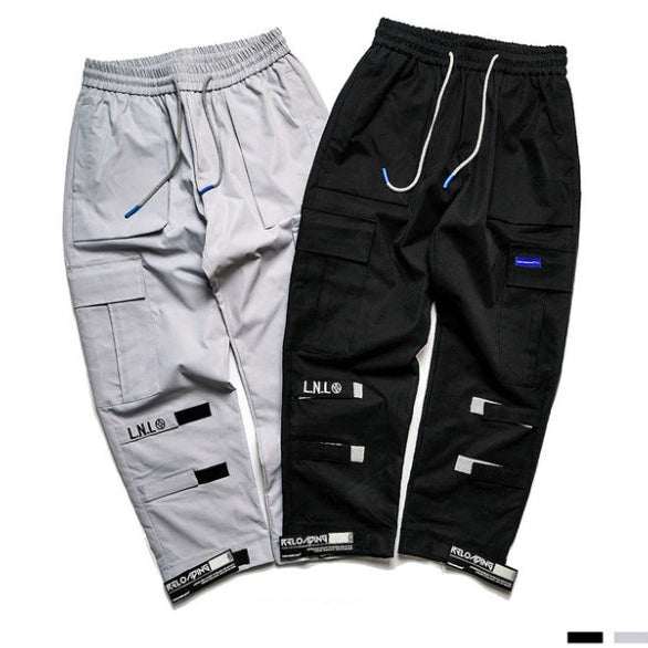 Two pairs of VantageGo Streetwear Joggers in gray and black cotton fabric with cargo pockets and drawstring waistbands